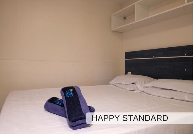 Letto matrimoniale con asciugamani blu.